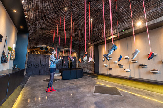 Tracey Neuls Coal Drops Yard New Boutique with shoes hanging from with ceiling with ribbon