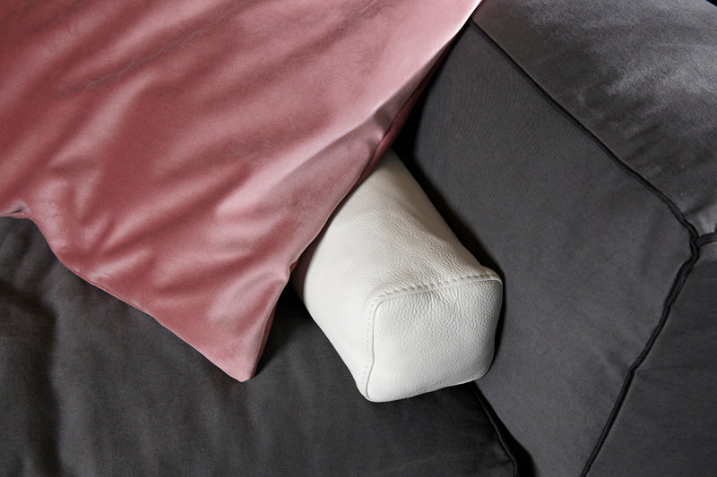 Elementary store white cushion and pink cushion on grey sofa, minimal stylish scandinavian interior design