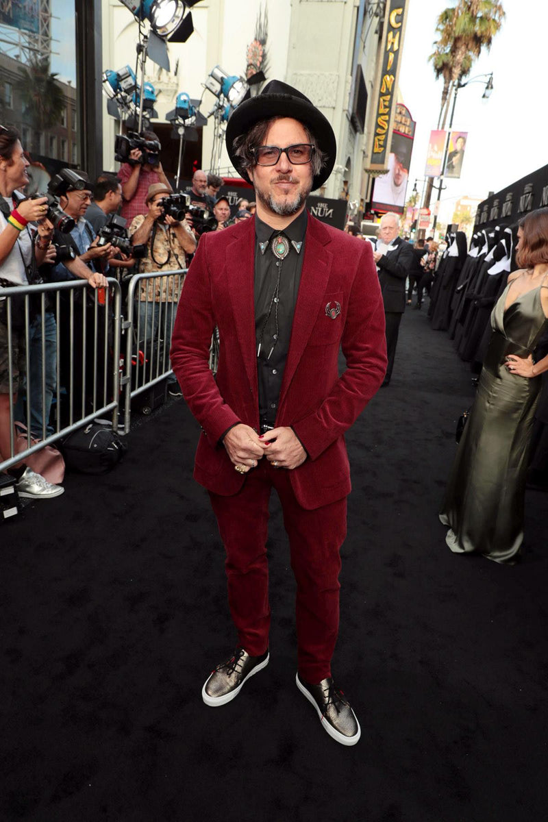 Director COrin Hardy wearing red suit and Tracey Neuls trainers at LA film premiere 