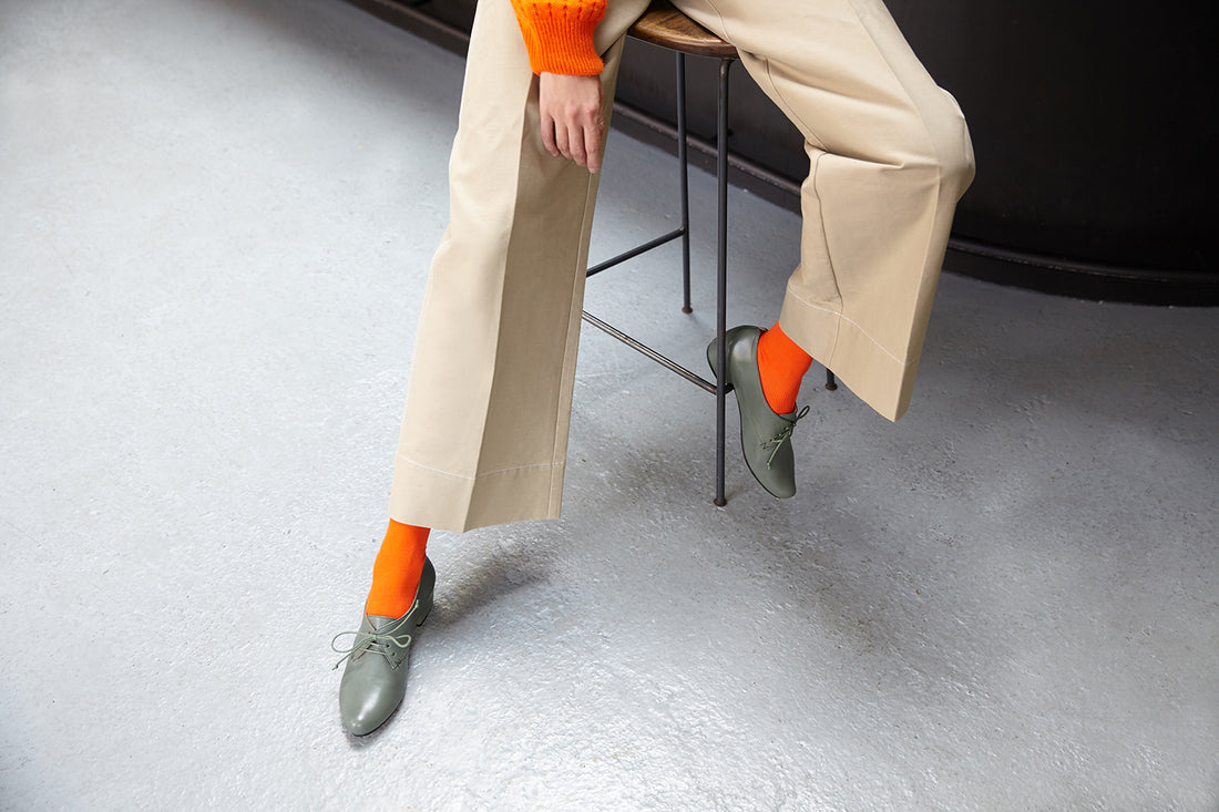 Tracey Neuls model wears bright orange socks with calf leather hand crafted leather mid heel brogues for women