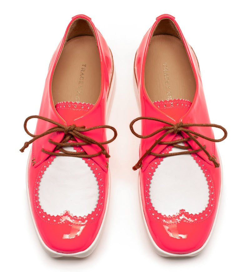 Pair of deep pink patent lace up shoes with white heart design, by shoe designer Tracey Neuls