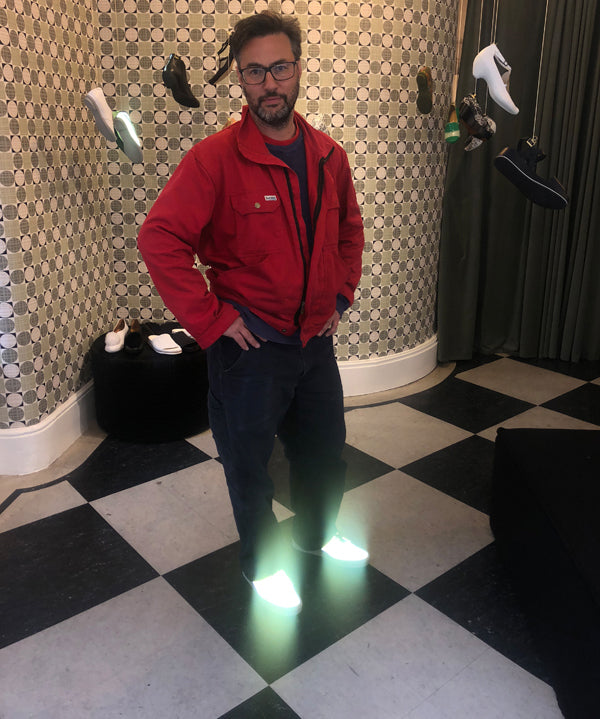 Adam Hills of the London salvage design company Retrouvius wearing Tracey Neuls designer smart casual reflective hi-vis sneakers in our Marylebone boutique