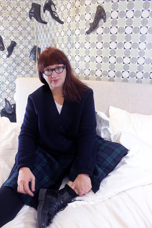 Interview with designer Tracey Neuls sitting on a Matthew Hilton Bed