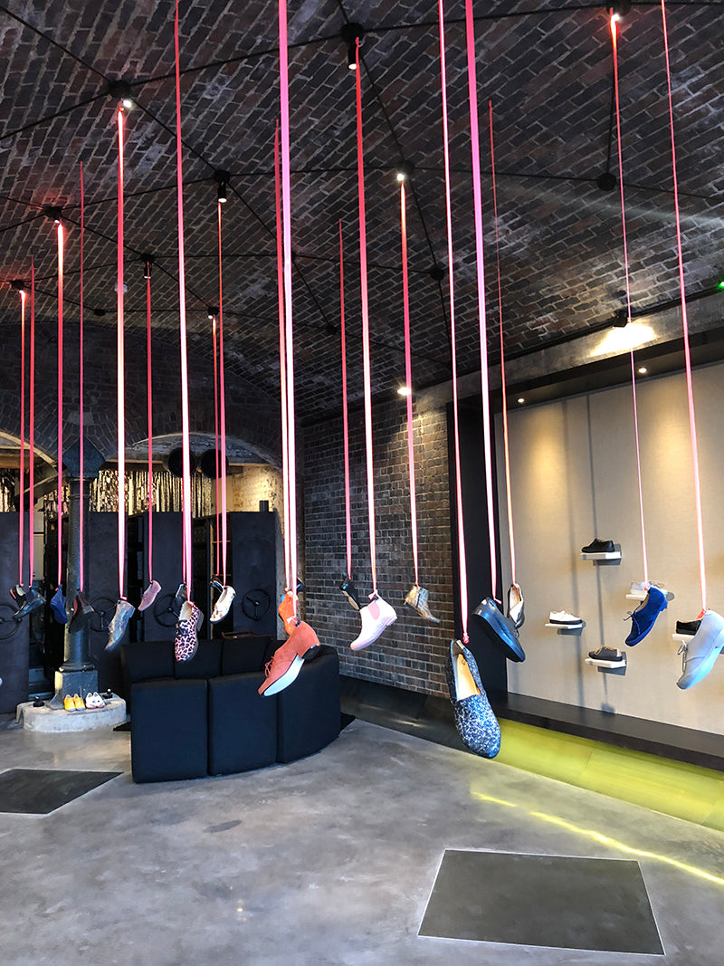 Tracey Neuls Coal Drops Yard where shoes hang from the ceiling on ribbons