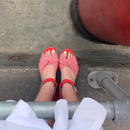 Red SS20 Sandals by Tracey Neuls, worn with white midi dress and gold painted toes, next to a London postbox