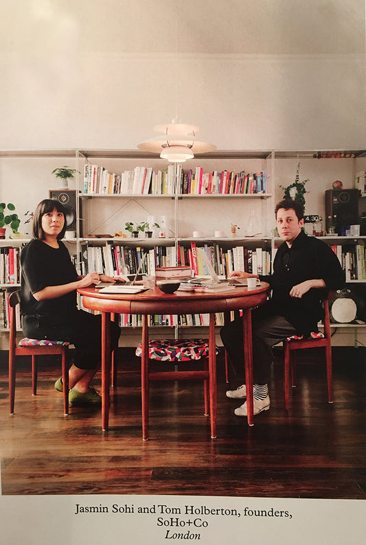 man and woman sat at a wooden table