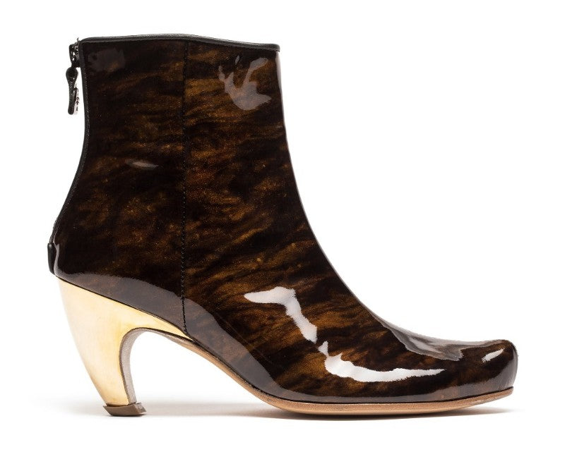 Product shot of mahogany patent leather women's boot with gold high heel 