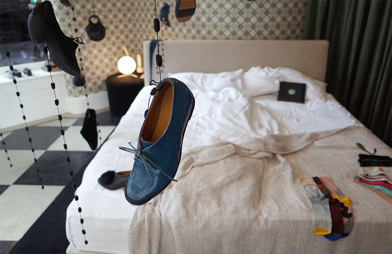 bed display blue petrol shoe hanging from ceiling