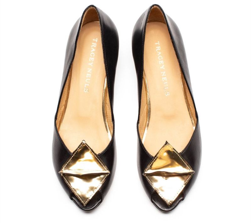 A pair of black and gold mid heel Italian leather slip on shoes by designer Tracey Neuls