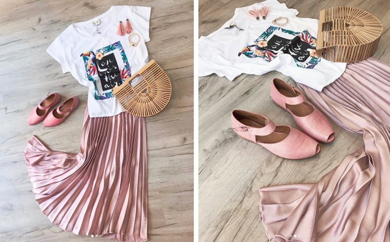 style display of pink silk skirt, patterned white t shirt, woven wicker bag and pink shoes, laid out on floorboards